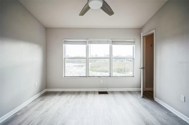 empty room featuring ceiling fan and light wood-type flooring