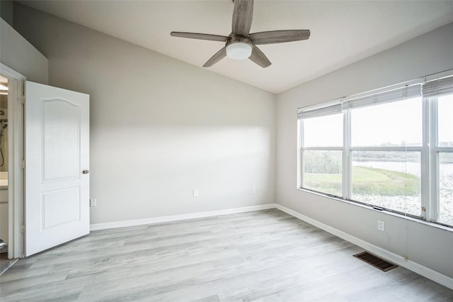 spare room featuring a wealth of natural light, ceiling fan, light hardwood / wood-style flooring, and lofted ceiling