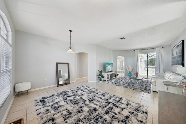 living room with light tile patterned floors and a textured ceiling