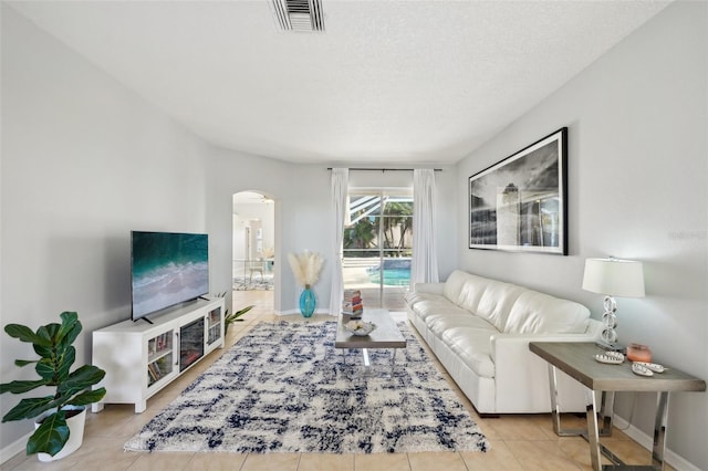 tiled living room with a textured ceiling