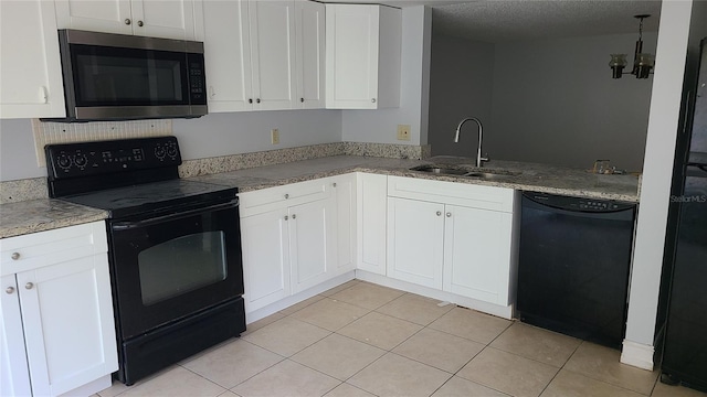 kitchen with light tile patterned flooring, white cabinetry, sink, black appliances, and a textured ceiling