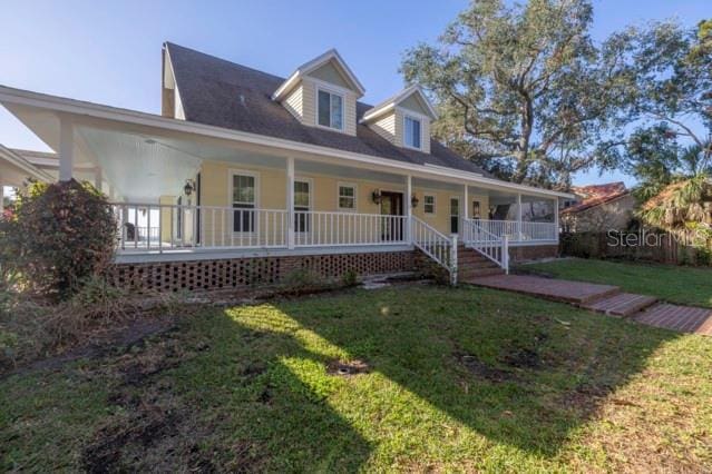 view of front of home with a porch and a front yard