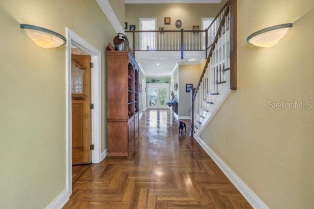 hall featuring dark parquet floors and ornamental molding