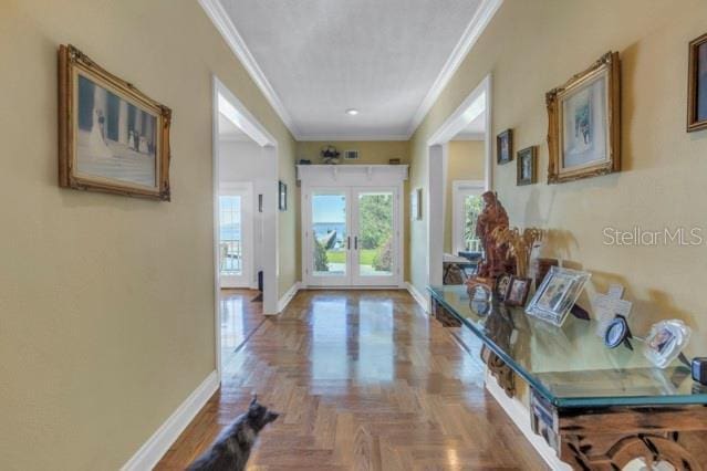 hall featuring parquet flooring and crown molding