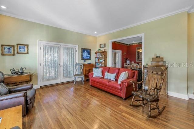 living room featuring wood-type flooring, french doors, and ornamental molding