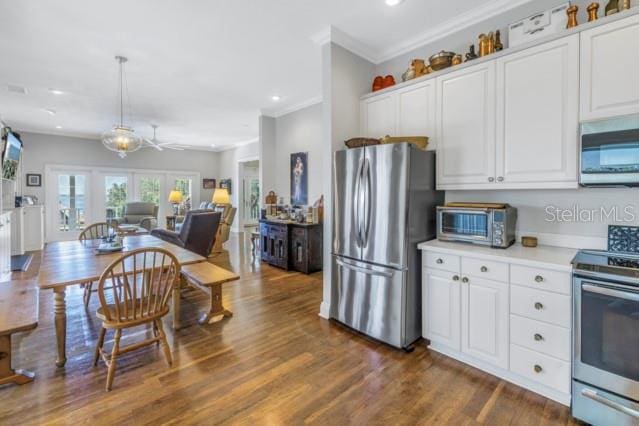 kitchen with dark hardwood / wood-style floors, white cabinetry, and stainless steel appliances