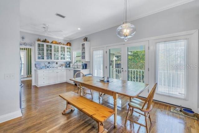 dining room with wood-type flooring, french doors, ceiling fan, and sink