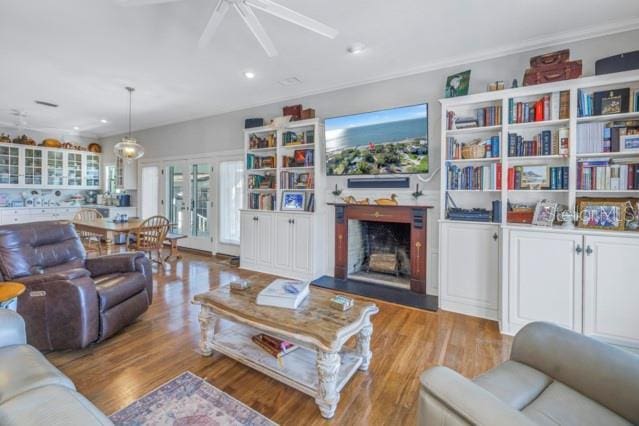 living room featuring ceiling fan, french doors, and light hardwood / wood-style flooring