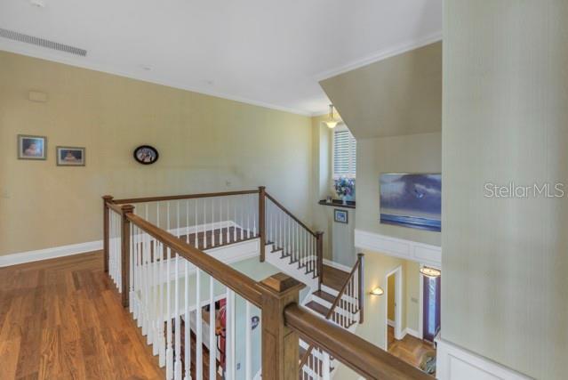 staircase with hardwood / wood-style floors