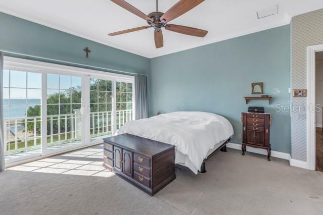 bedroom featuring access to exterior, ceiling fan, a water view, and light carpet