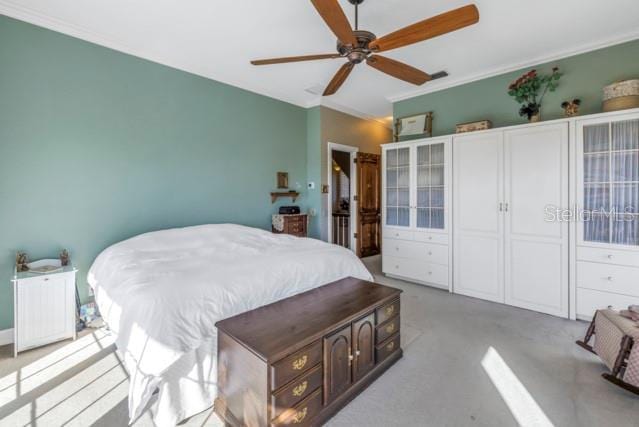 bedroom with ceiling fan and crown molding