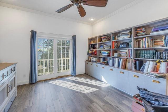 interior space with crown molding, ceiling fan, and light wood-type flooring