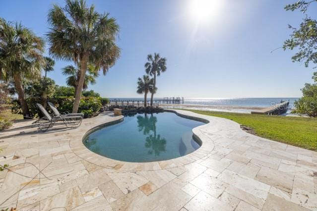 view of swimming pool featuring a water view and a patio