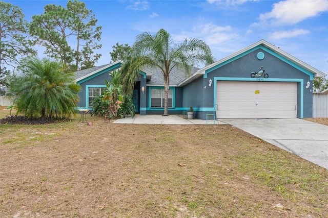 ranch-style home with stucco siding, a front yard, concrete driveway, and an attached garage