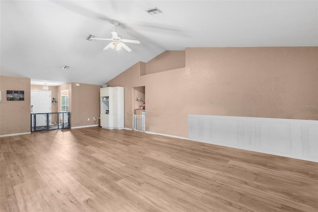 unfurnished living room featuring visible vents, ceiling fan, baseboards, lofted ceiling, and wood finished floors