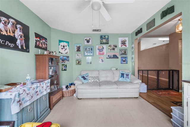 living area featuring wood finished floors and ceiling fan