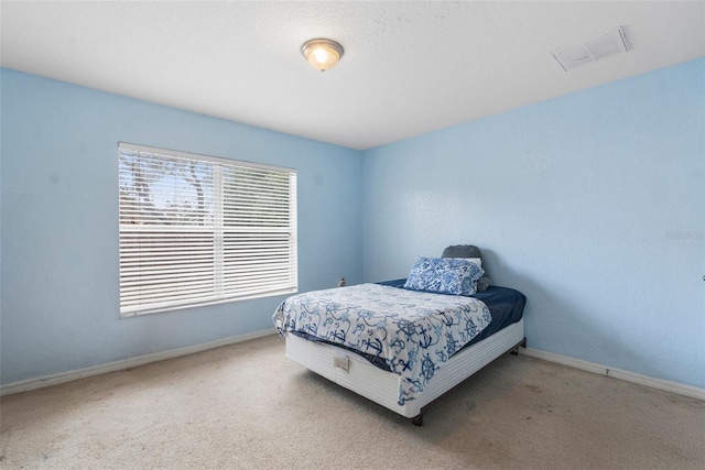 bedroom with visible vents, baseboards, and carpet floors