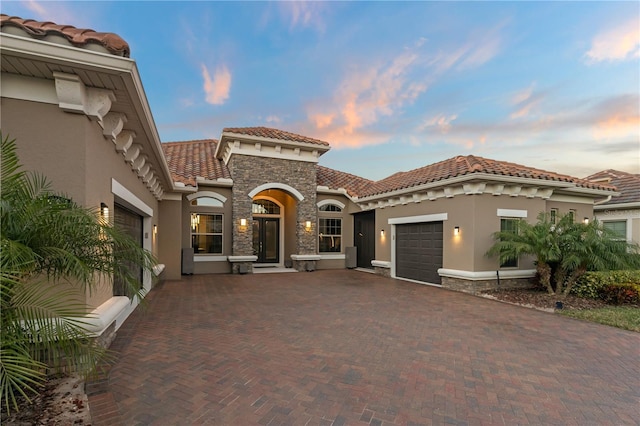 mediterranean / spanish home featuring a garage