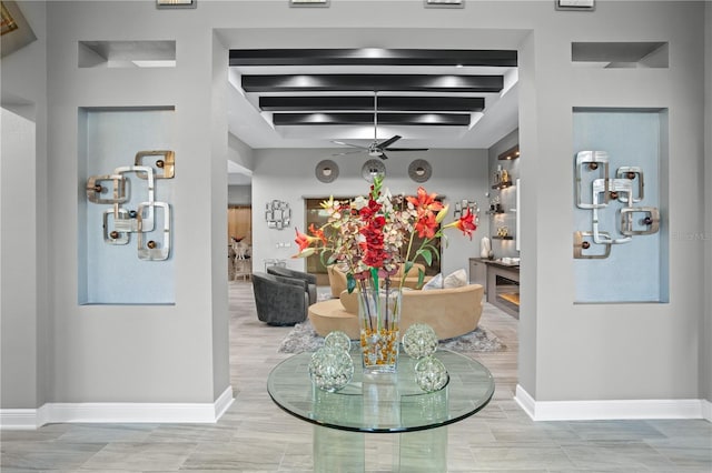 dining space with ceiling fan and beamed ceiling