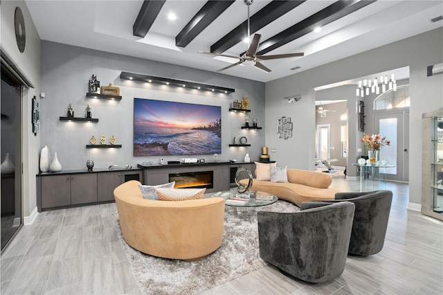 living room with ceiling fan and beam ceiling