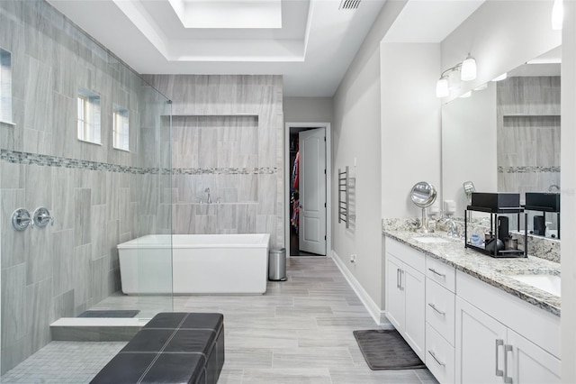 bathroom with vanity and a tub to relax in