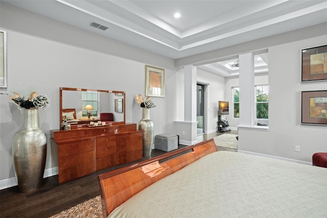 bedroom featuring a tray ceiling and wood-type flooring