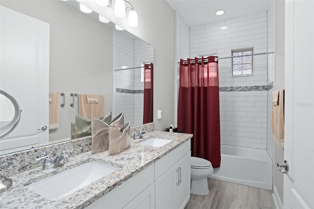 full bathroom with toilet, hardwood / wood-style flooring, vanity, and shower / bathtub combination with curtain