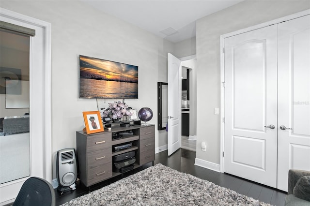 bedroom featuring dark hardwood / wood-style flooring and a closet