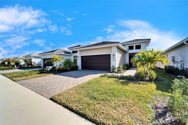 view of front of house with a garage and a front lawn