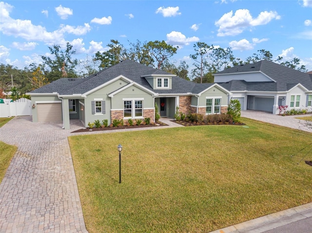 view of front of house with a garage and a front lawn