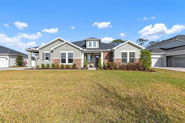 view of front of property with a front yard and a garage