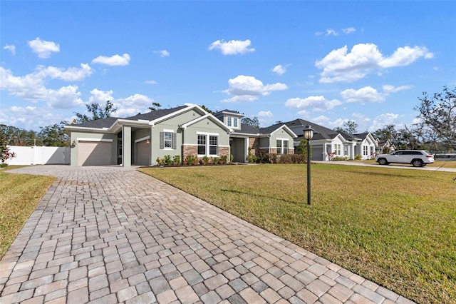 view of front of house featuring a garage and a front lawn