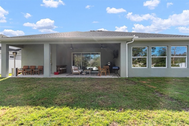 back of house featuring ceiling fan, a yard, a patio, and an outdoor living space