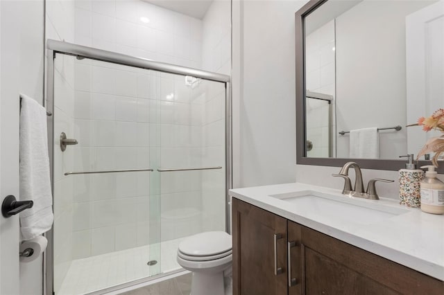 bathroom featuring vanity, toilet, and walk in shower