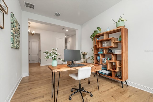 office space featuring light hardwood / wood-style flooring and a notable chandelier