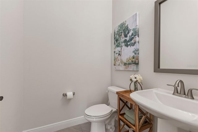 bathroom featuring tile patterned floors, sink, and toilet