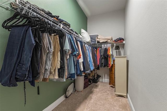 walk in closet with carpet