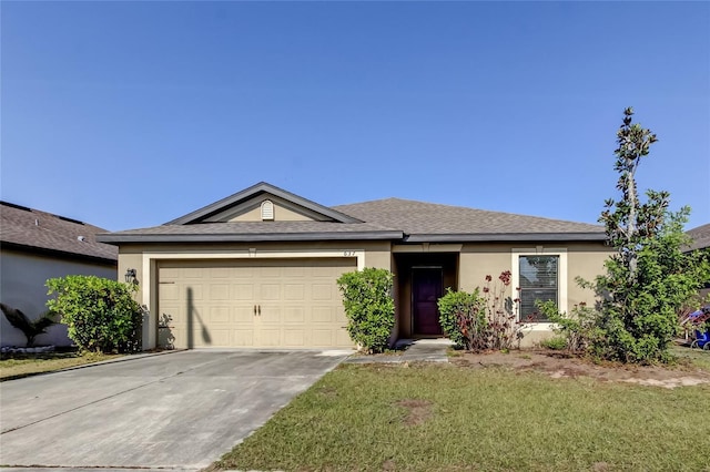 ranch-style home with a front lawn and a garage