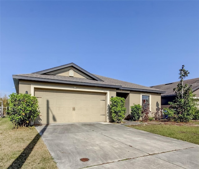 ranch-style home with a front lawn and a garage