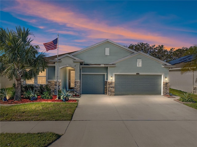 view of front of home featuring a garage and a lawn