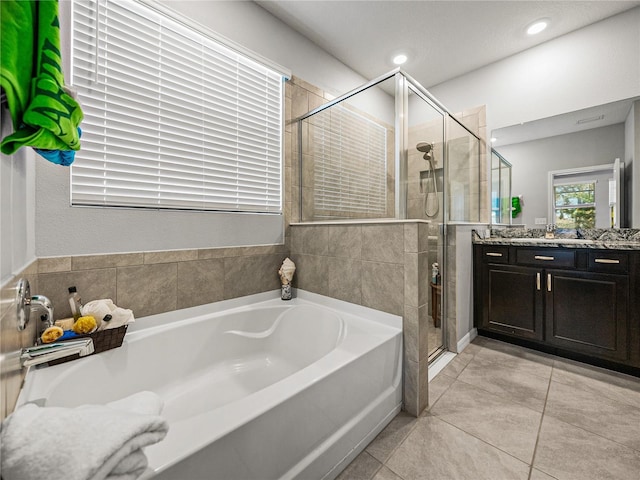 bathroom featuring tile patterned floors, separate shower and tub, and vanity