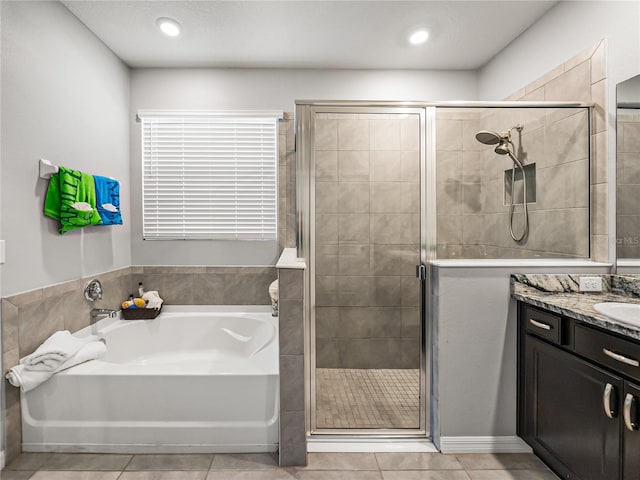 bathroom with tile patterned floors, separate shower and tub, and vanity