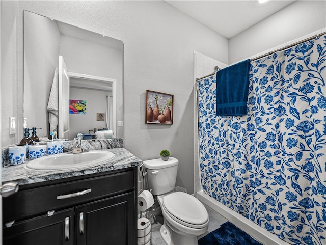 bathroom with toilet, vanity, and a shower with curtain