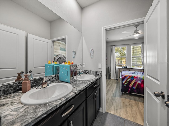 bathroom featuring ceiling fan, tile patterned floors, and vanity