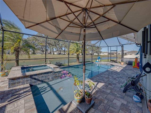 view of pool with a patio area, glass enclosure, an in ground hot tub, and a water view