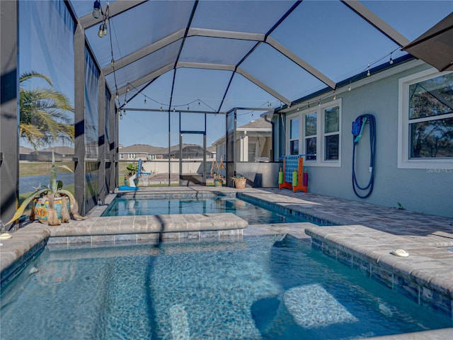 view of pool featuring a lanai, a patio, and a jacuzzi