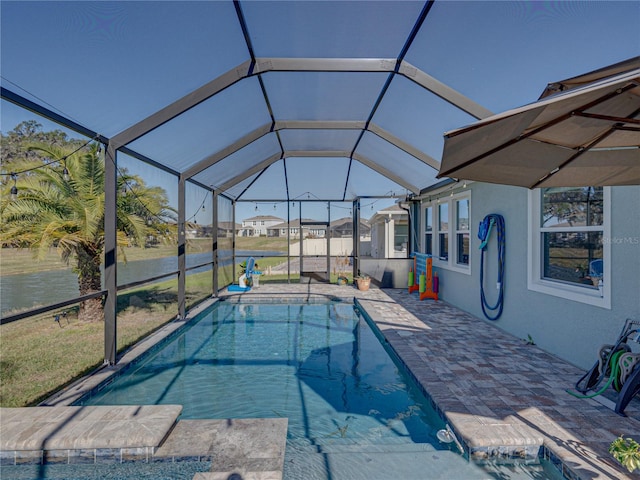 view of swimming pool featuring a lanai, a water view, and a patio area