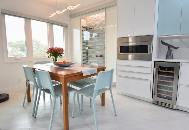 dining room featuring light tile patterned floors and beverage cooler