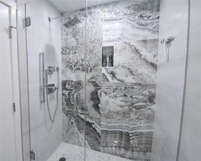 bathroom with a shower with shower door