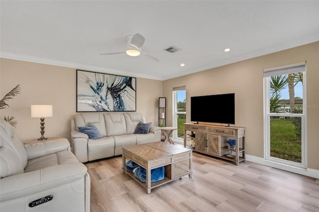 living room with ceiling fan, light hardwood / wood-style floors, crown molding, and a wealth of natural light